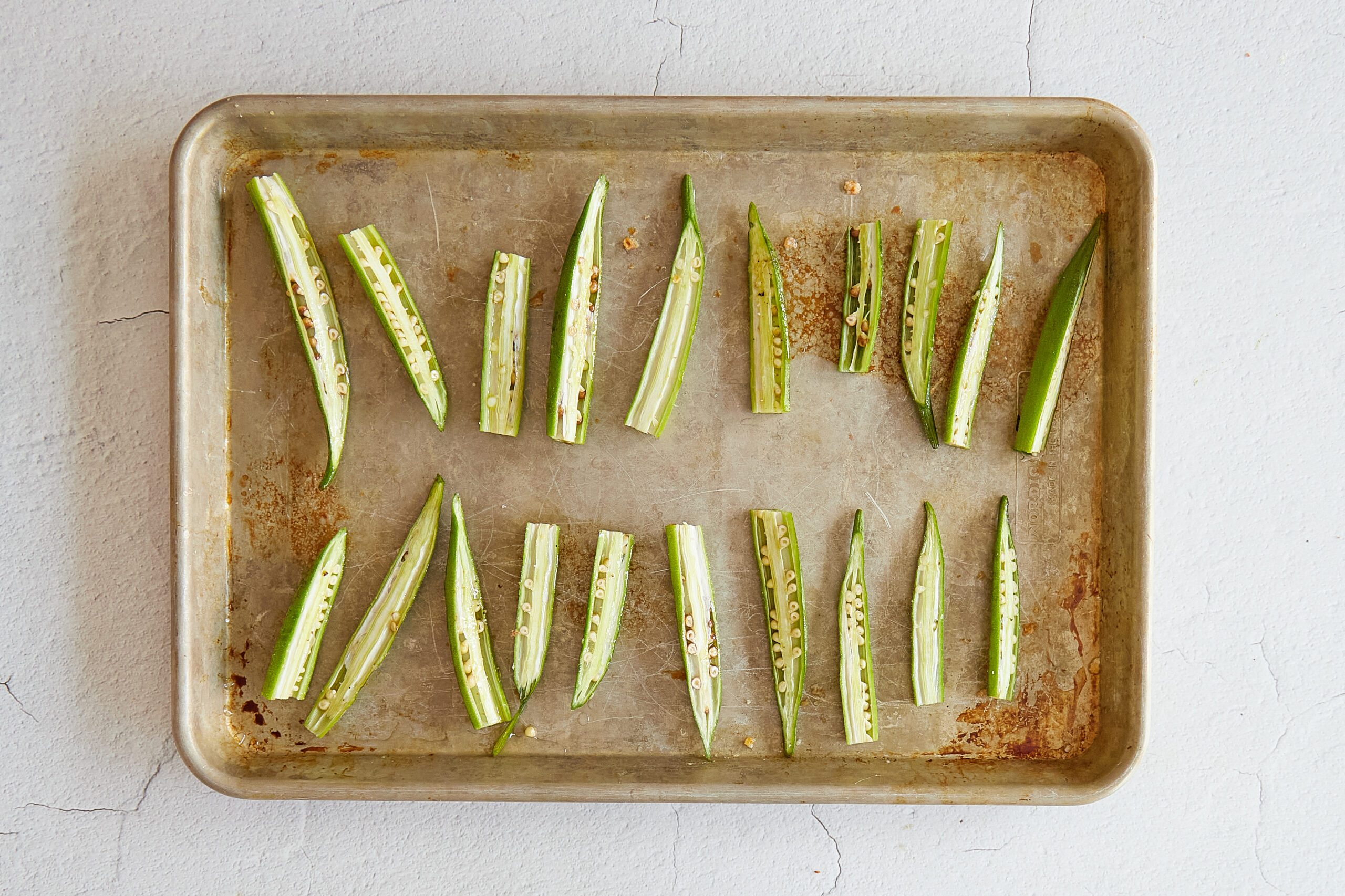 Arrange the okra on a baking sheet.
