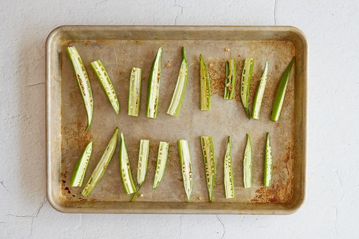 Arrange the okra on a baking sheet.