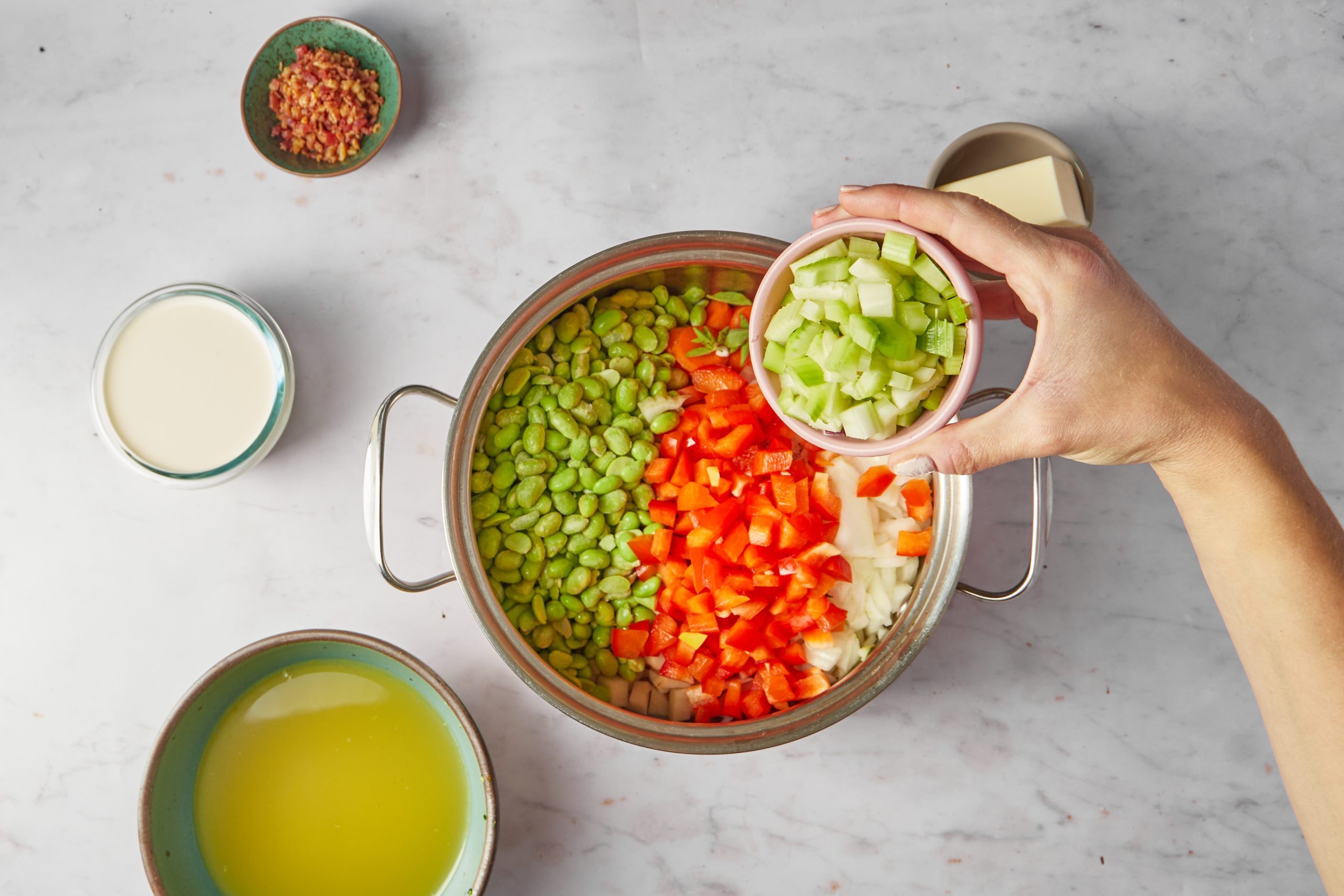 Cook the vegetables for lima bean soup.