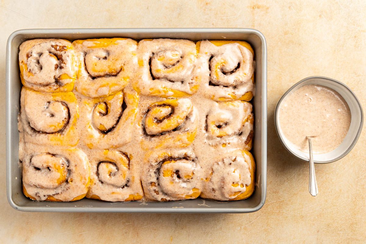 Taste of Home Pumpkin Cinnamon Rolls recipe photo of the rolls spread with the glaze.