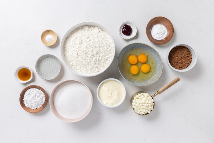 Ingredients for red velvet crinkle cookies on kitchen counter.