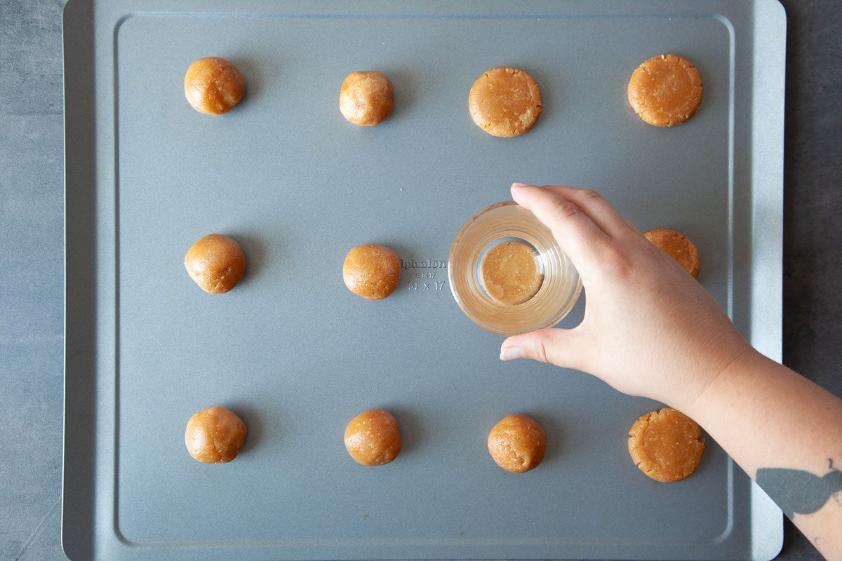 Step 2 of Taste of Home Spider Cookies is to scoop by tablespoons onto baking sheets and flatten with a the bottom of a glass or cup