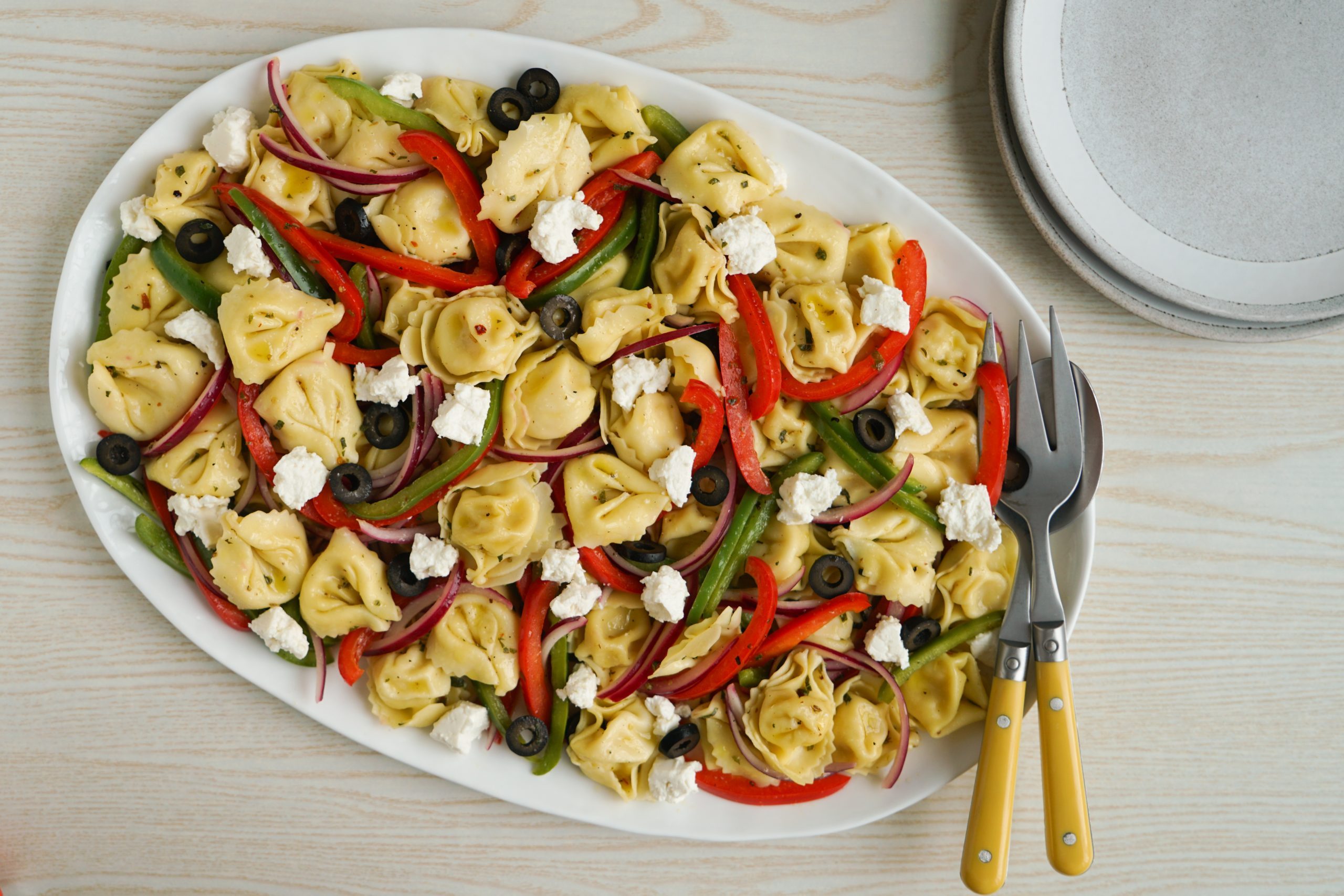 Tortellini pasta salad on a white platter
