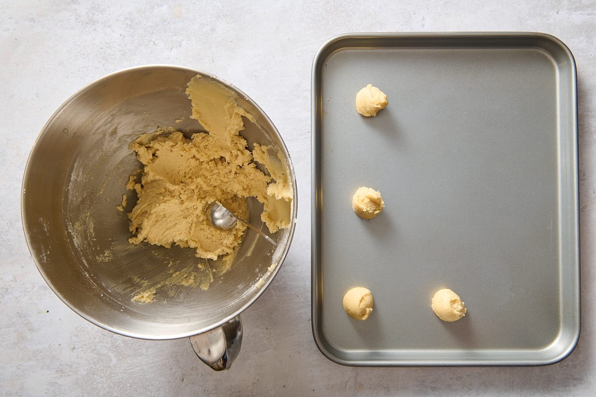 Dropping spoonfuls of the dough onto a baking sheet