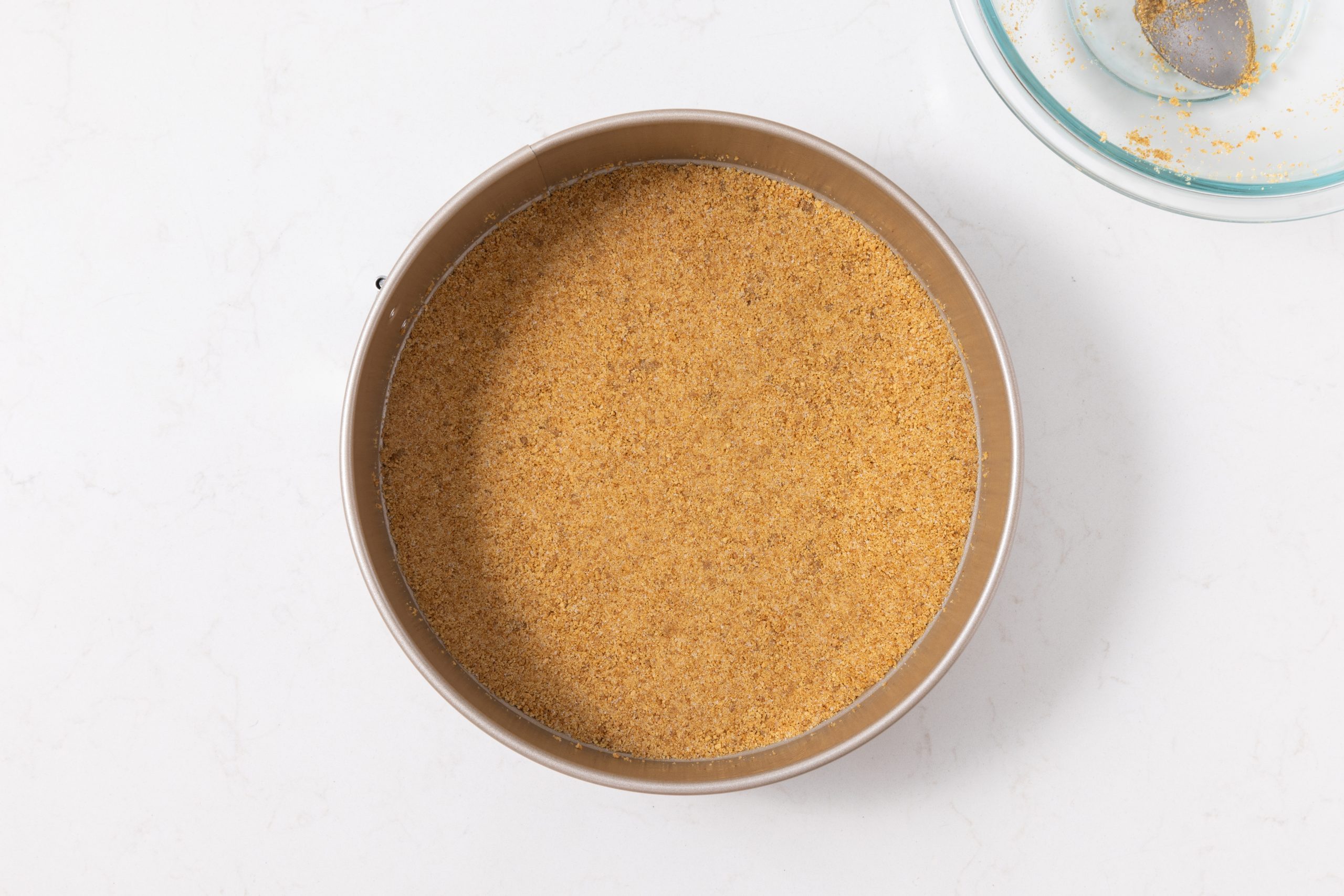 Cheesecake crust pressed into springform pan.