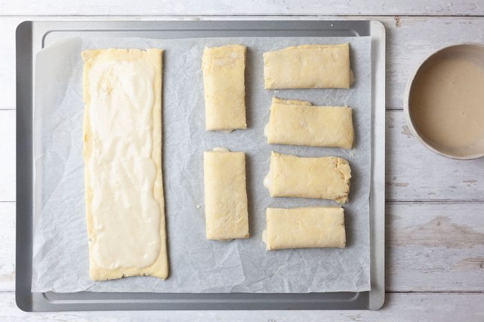 Step 4 of Taste of Home Bear Claw is to beat the egg white until foamy. Gradually add the confectioners' sugar and almond paste; beat until smooth. Cut the dough in half widthwise. Roll each portion into a 12-inch square; cut each square into three 12x4-inch strips. Spread about two tablespoons of filling down the center of each strip. Fold the dough over the filling starting with a long side and pinch the seam to seal. Cut it into three pieces.