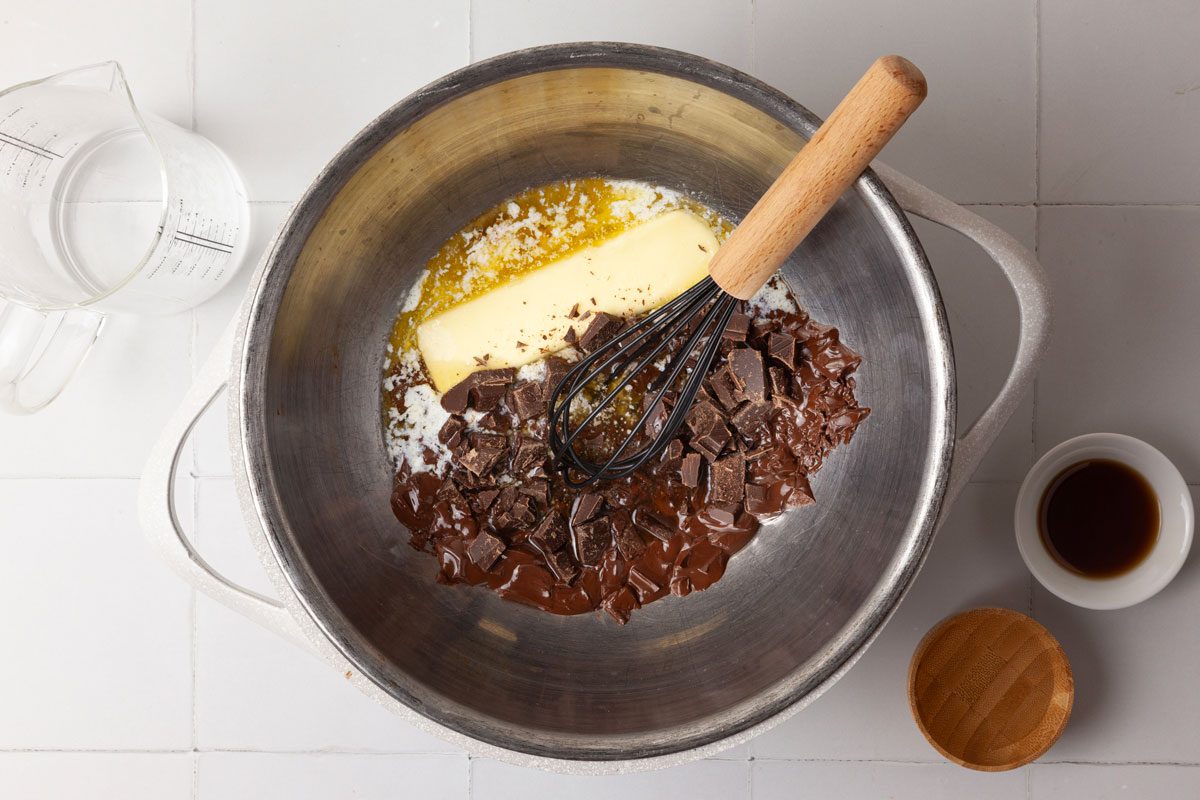 Step 4 of Taste of home Brooklyn Blackout Cake is to melt the chocolate and butter in a double boiler or a metal bowl over hot water; stir until smooth. Remove from heat. Whisk in the hot water all at once. Whisk in the corn syrup and vanilla. Refrigerate for 25 to 30 minutes or just until spreadable.