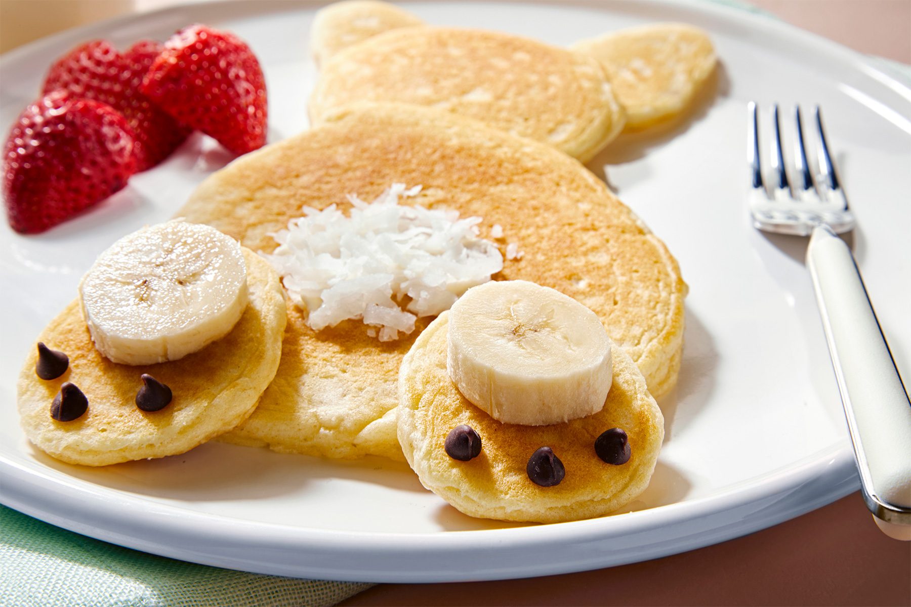 3/4th shot of fluffy bunny pancakes served with milk