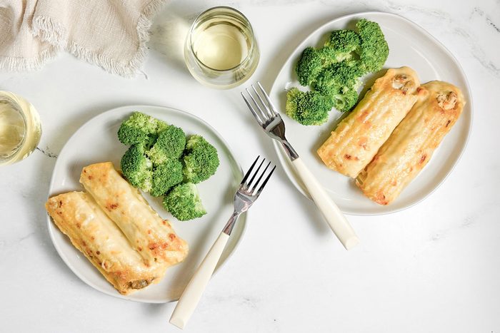 Taste of Home Chicken Manicotti with broccoli on white plates