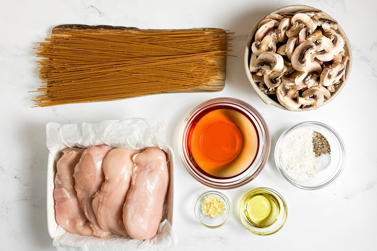 Ingredients for Taste of Home Chicken Marsala on a marble surface