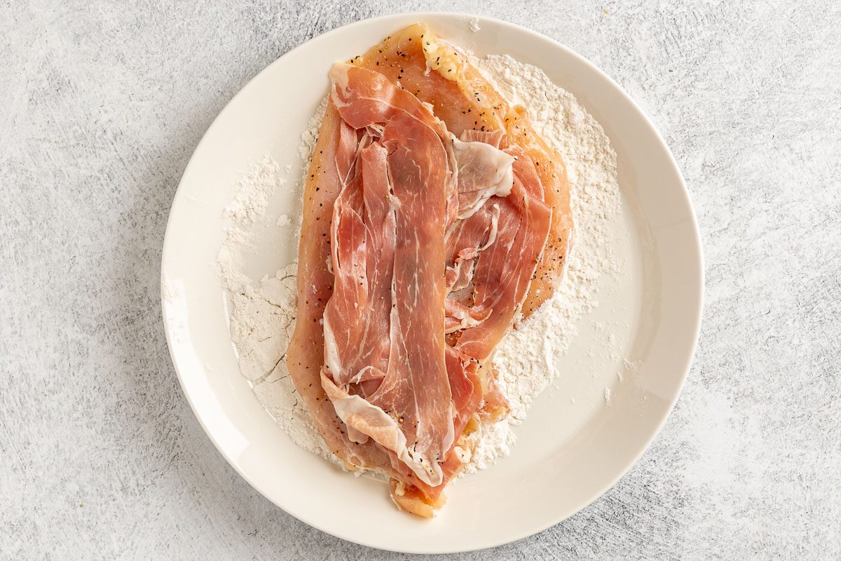 Taste of Home Chicken Saltimbocca photo of the pounded chicken breast topped with fresh sage, proscuitto and then dredged in flour chicken side only.