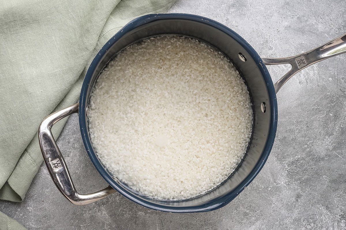 Soaking sushi rice in a saucepan to make chicken tempura roll for a Taste of Home recipe.