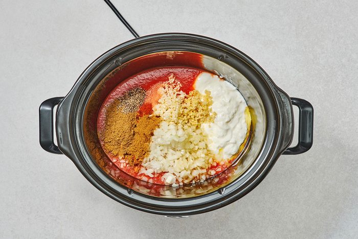 Sauce ingredients in a slow cooker before being mixed