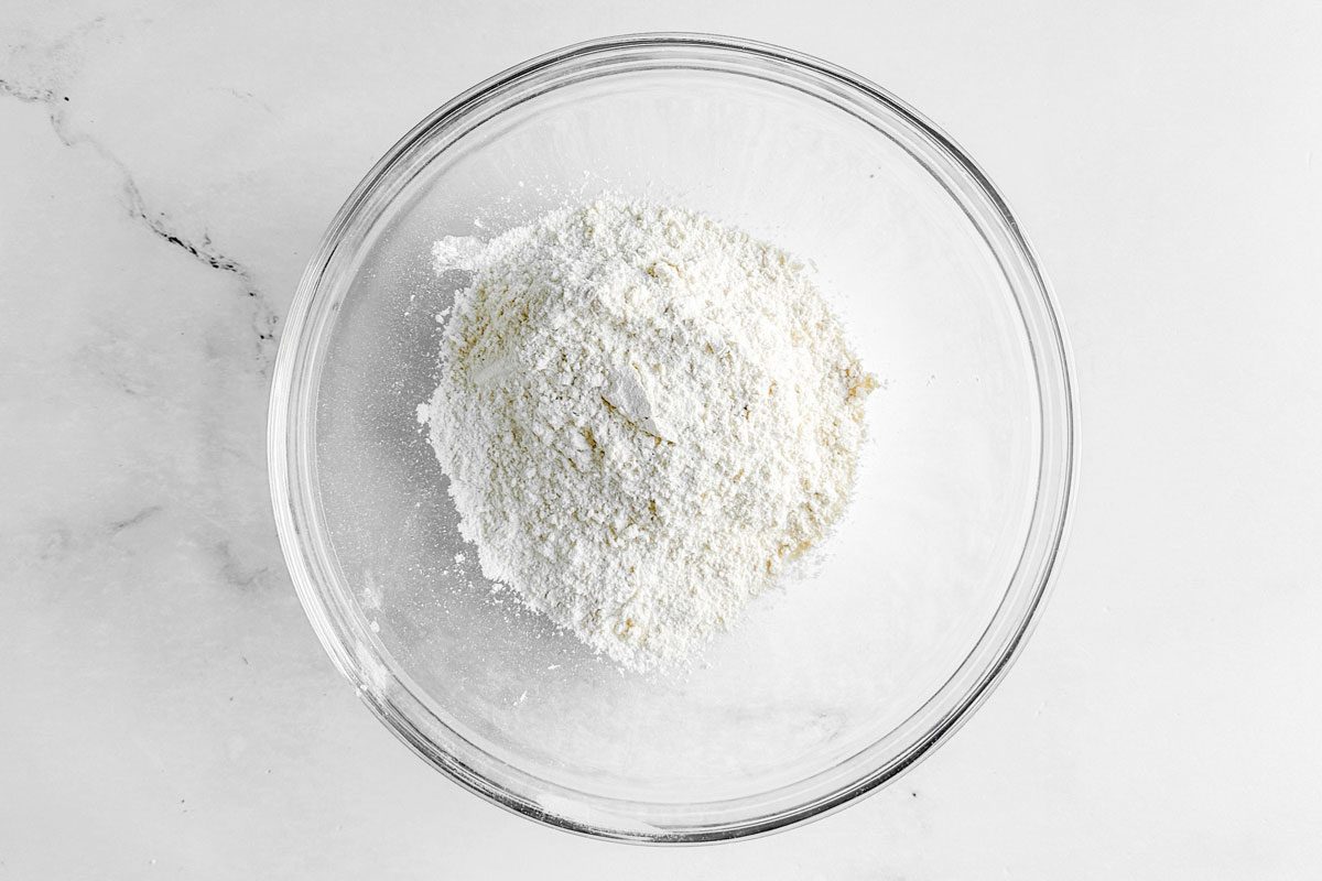 Ingredients for Taste of Home Chocolate Chip Scones in a glss bowl on a marble surface