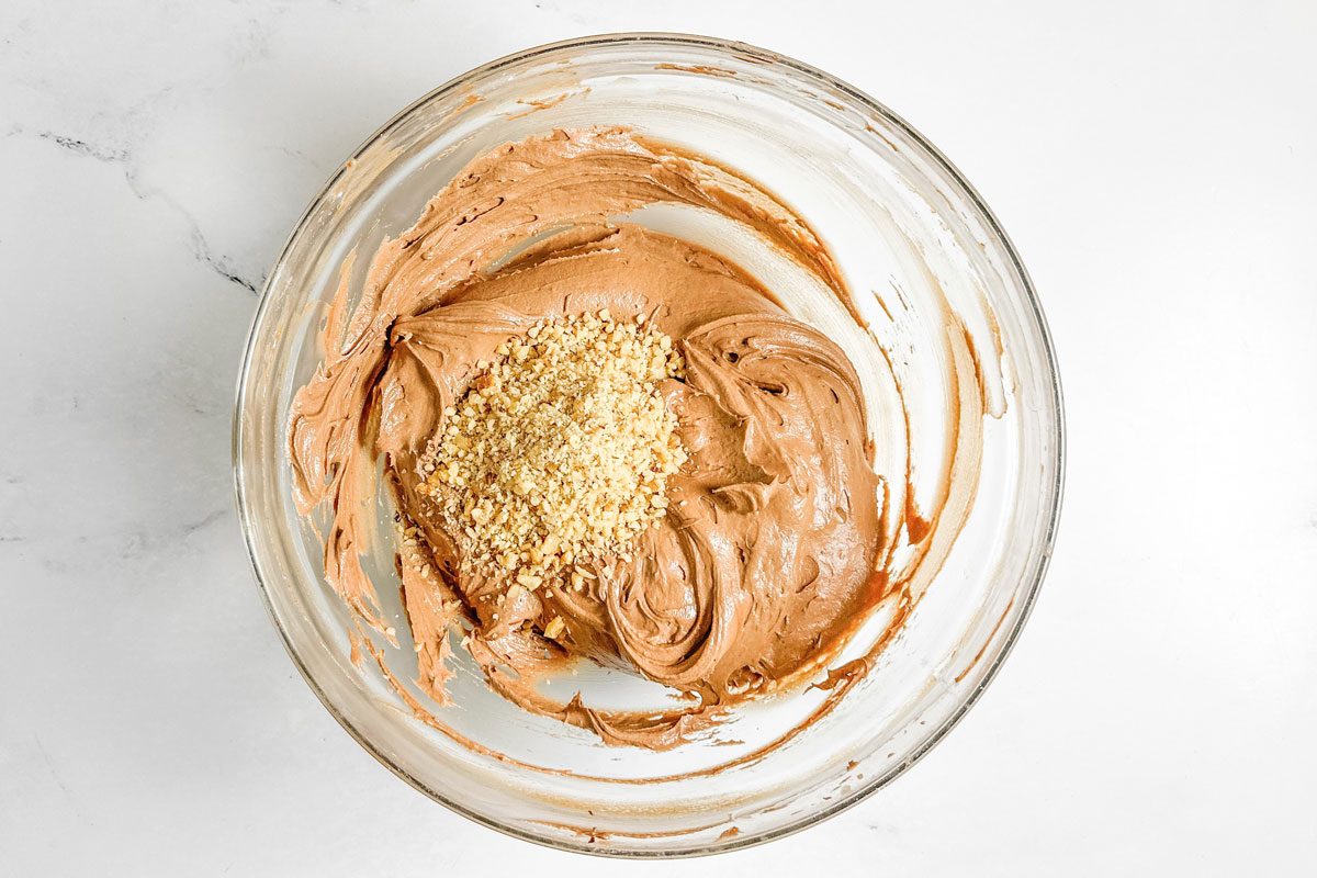 Batter for Taste of Home Chocolate Drop Cookies in a glass bowl on a marble surface