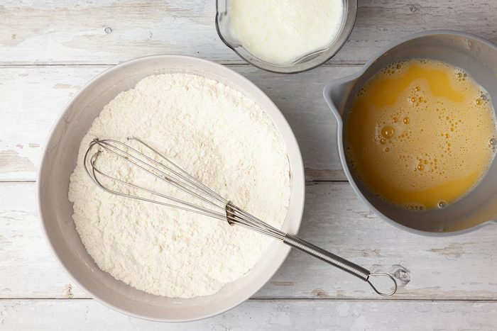 Step 1 of Taste of Home Chocolate Chip Pancakes is to combine the flour, sugar, baking powder, baking soda and salt in a large bowl. Mix the eggs, buttermilk and some vegetable oil in another bowl. Gradually add the wet ingredients to the dry, stirring until just moistened