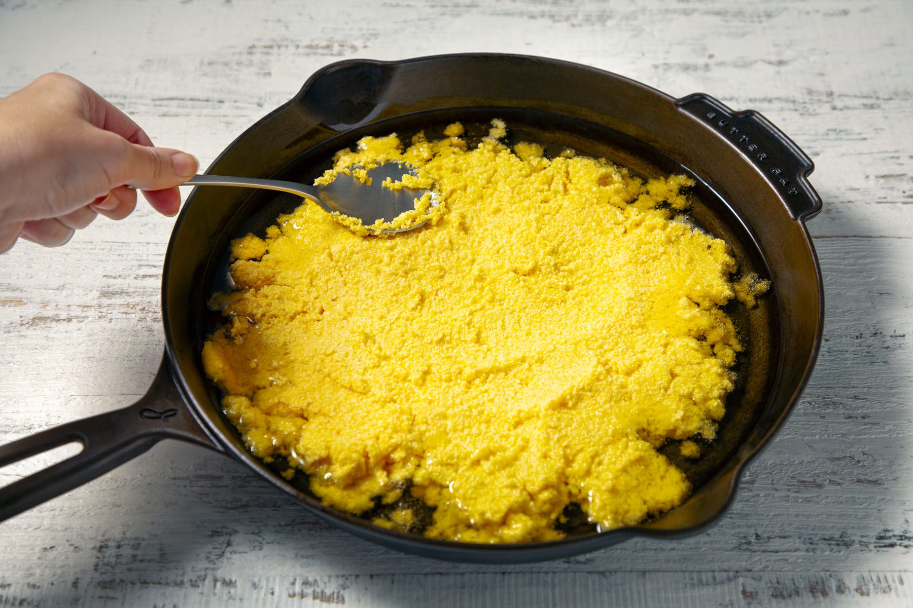 spread mixture evenly in preheated skillet, spooning some of the oil on top of batter.