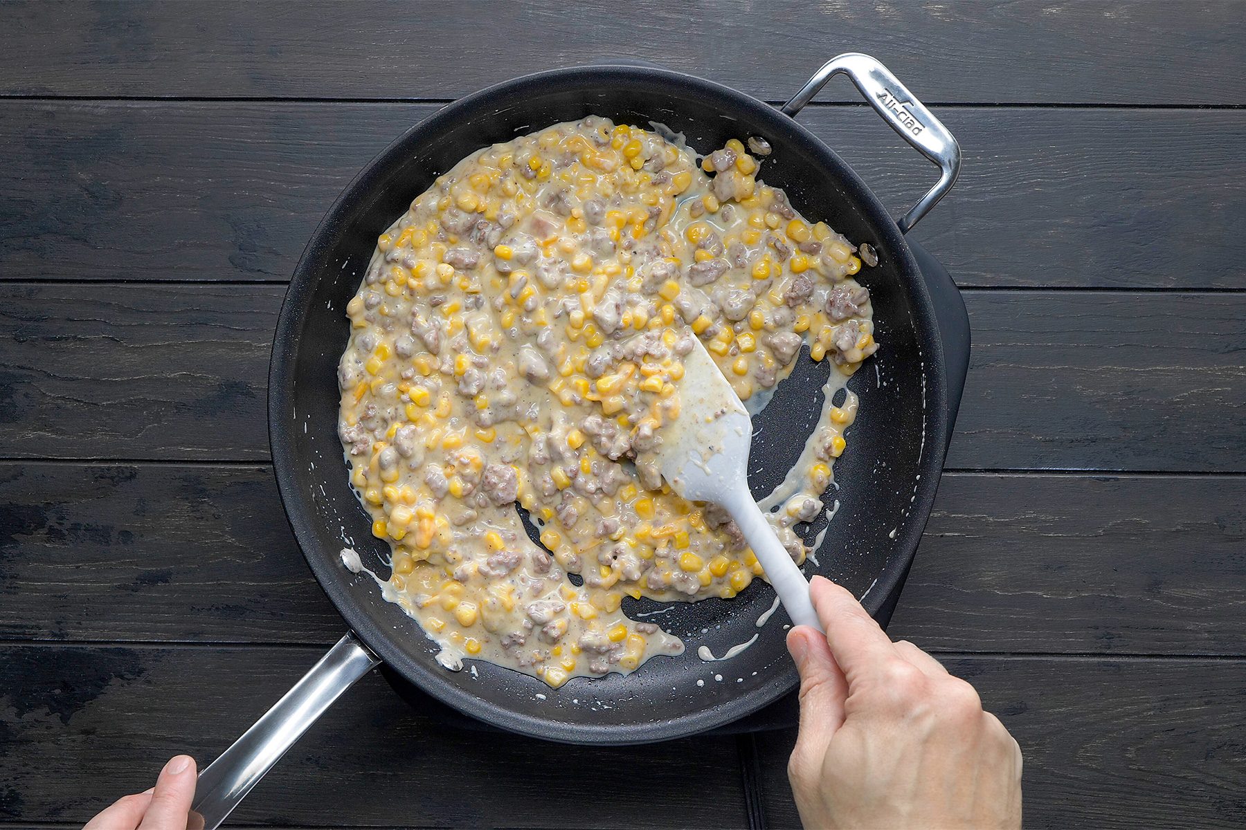 Stir in the corn, soup, cheese, milk and other ingridients in a skillet