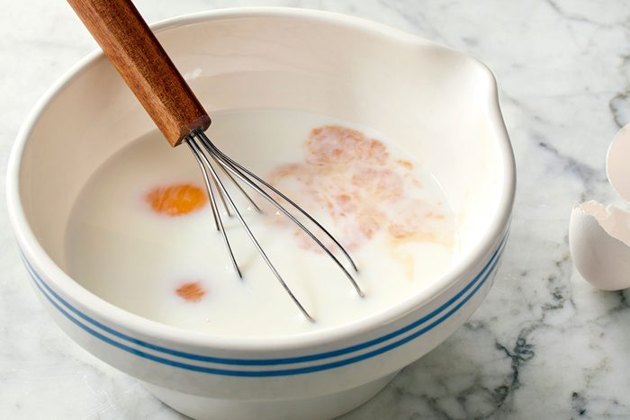 eggs, milk and vanilla mixed in a bowl.