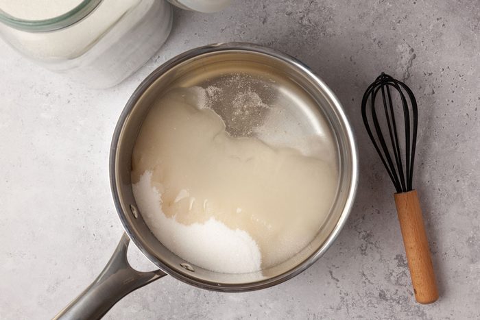 Step 2 of Taste of Home Hard Candy is to combine the sugar, corn syrup and water, then bring them to a boil over medium heat, stirring occasionally. Cover and continue cooking for three minutes without stirring, to dissolve any sugar crystals.