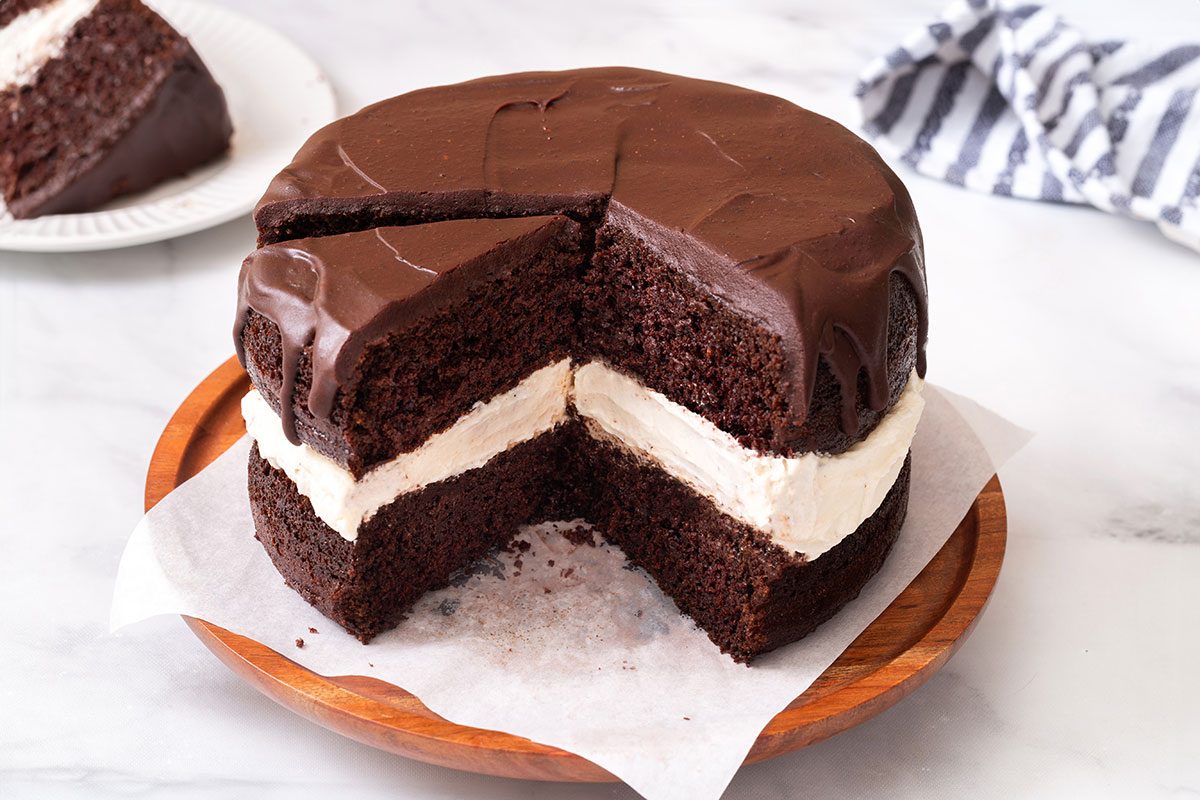 Sliced Ho Ho Cake on a cake stand for Ho Ho Cake recipe for Taste of Home