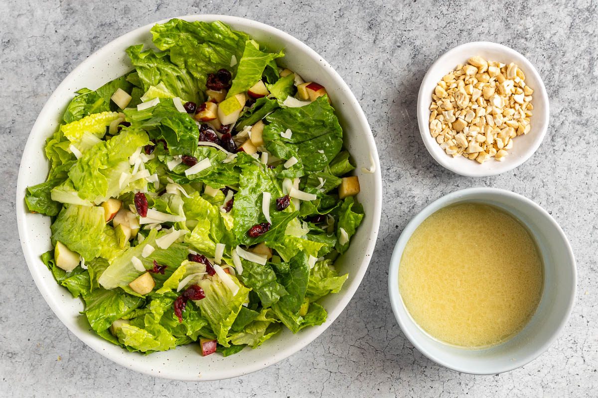 Taste of Home Holiday Salad recipe photo of the salad with the dressing and chopped cashews.