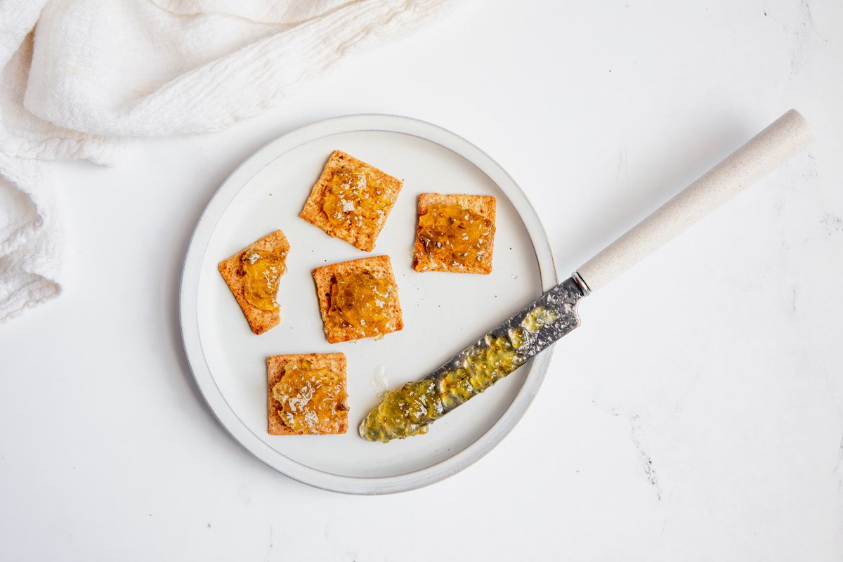 Overhead beauty shot for Taste of Home Jalapeno Jelly on crackers on a plate.