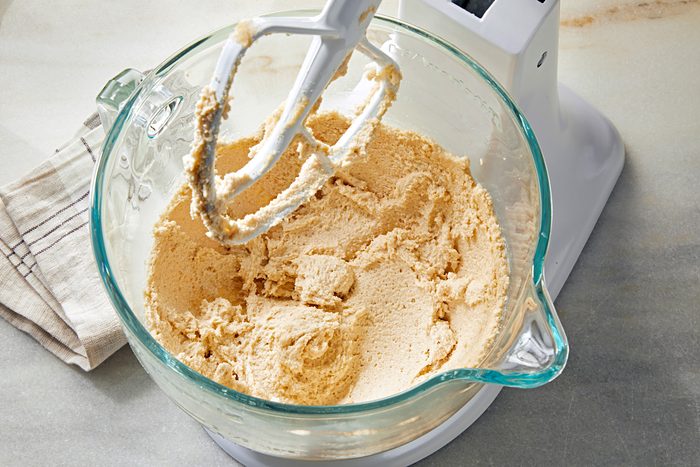 Top view shot of mixing shortening, sugar and brown sugar in a large bowl