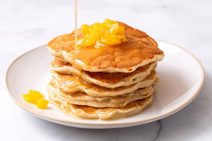 Peach Pancakes on a plate with drizzled butter syrup