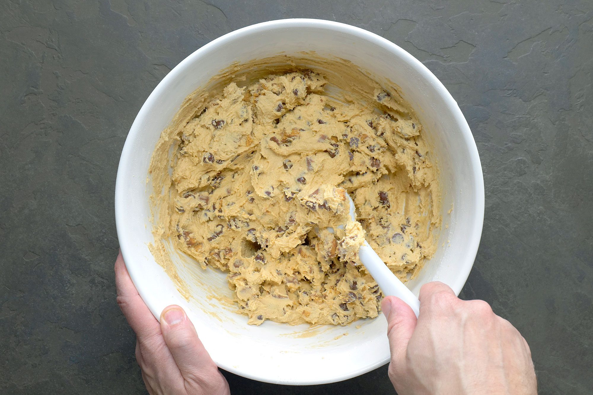 In the same white bowl add chocolate chips and mix it with spatula