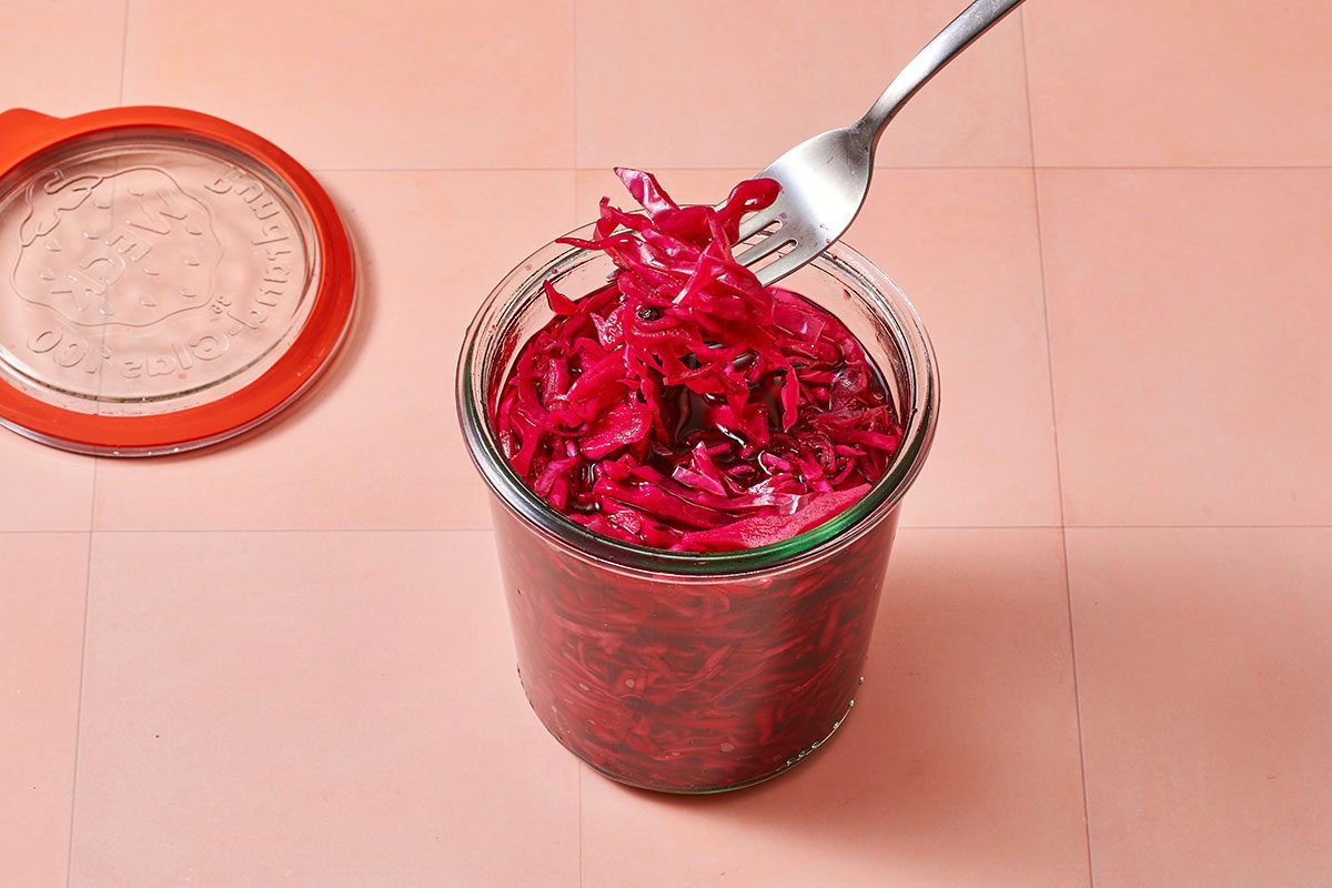 Red cabbage with brine transferred to jars