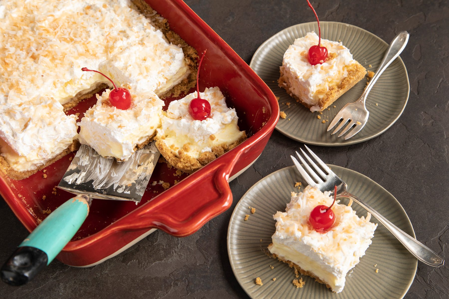 Pina Colada Lush in baking tray and served on grey plates with forks top view shot