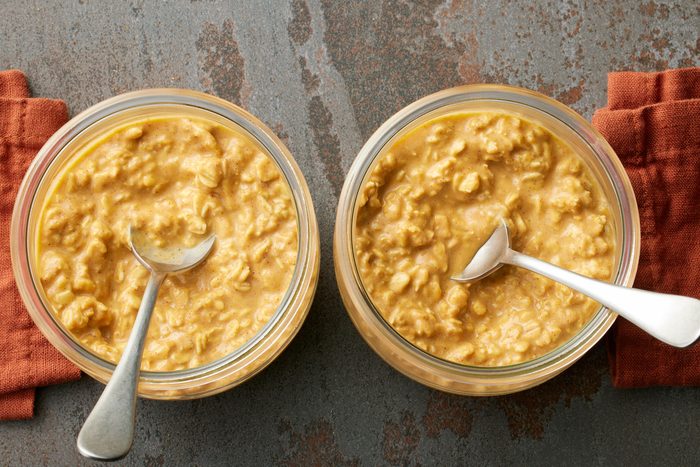 Pumpkin Overnight Oats in two containers with spoon