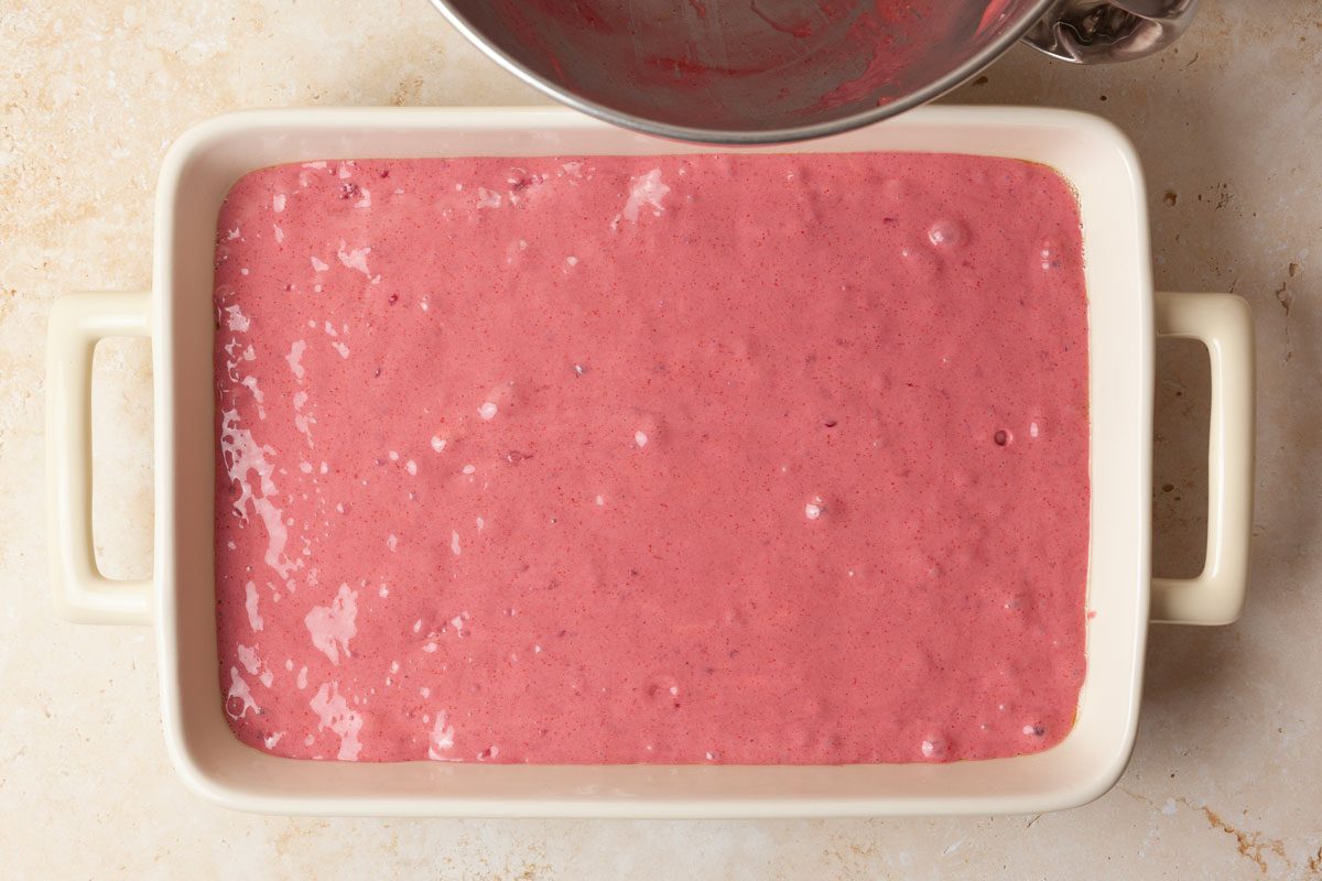 Step 2 of Taste of Home Raspberry Cake is to pour the batter into a greased 13x9-inch baking pan. Bake for 35 to 40 minutes in your preheated oven or until a toothpick inserted in the center comes out clean. Once baked, let the cake cool completely in the pan on a wire rack.