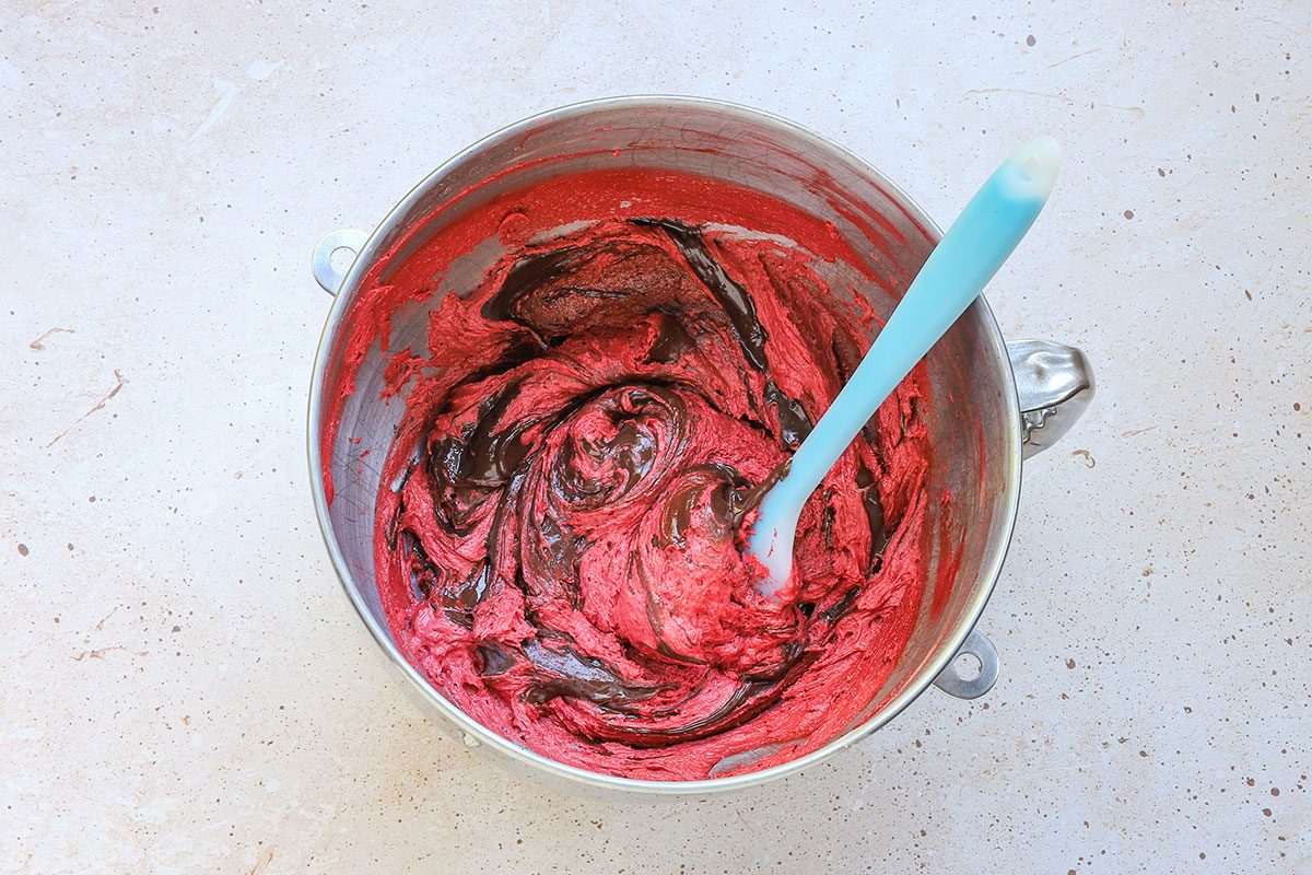 Melted chocolate is added to the red velvet whoopie pie batter, a recipe from Taste of Home.