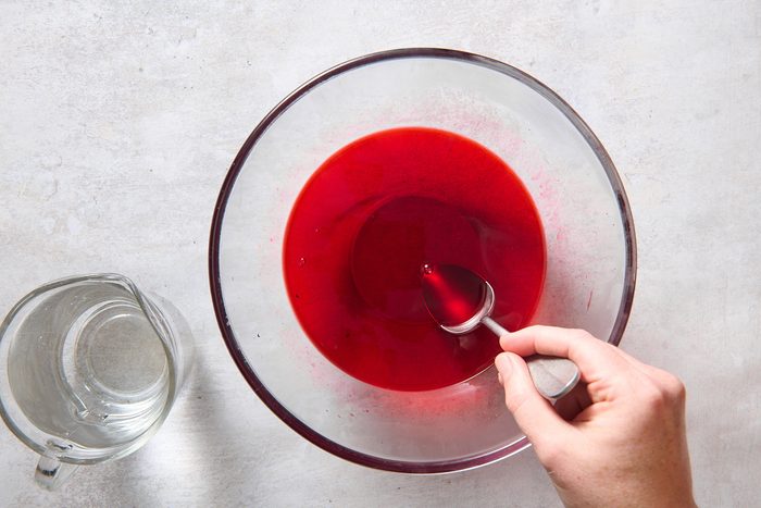 Preparing the top cherry jello layer