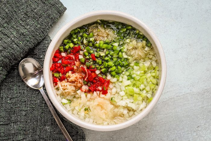 Combined ingredients in a bowl for sauerkraut salad, a recipe from Taste of Home.