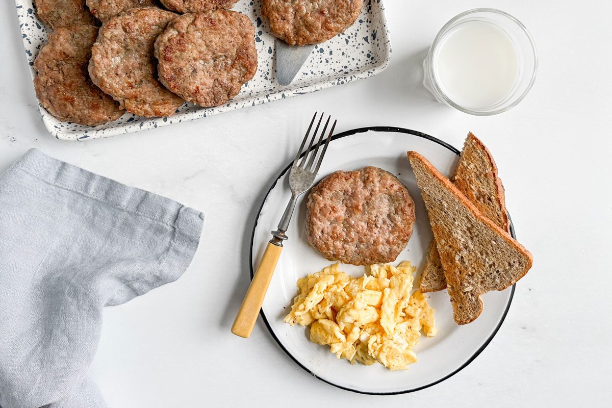 Taste of Home Sausage Patties on an enamel plate with toast and scrambled eggs