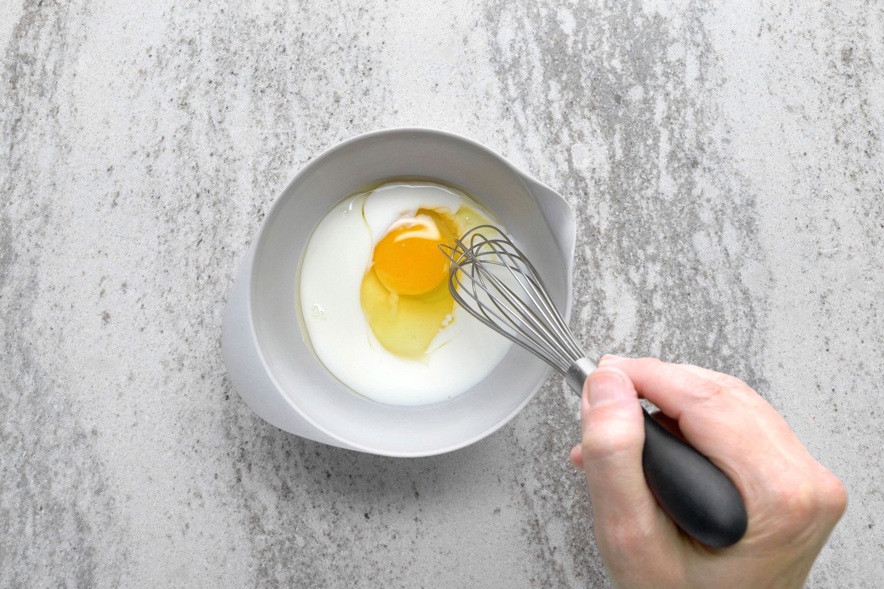 Egg and buttermilk whisked together in a small bowl.