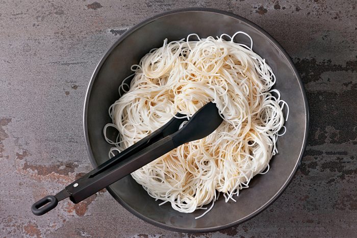Cook rice noodles in a large bowl