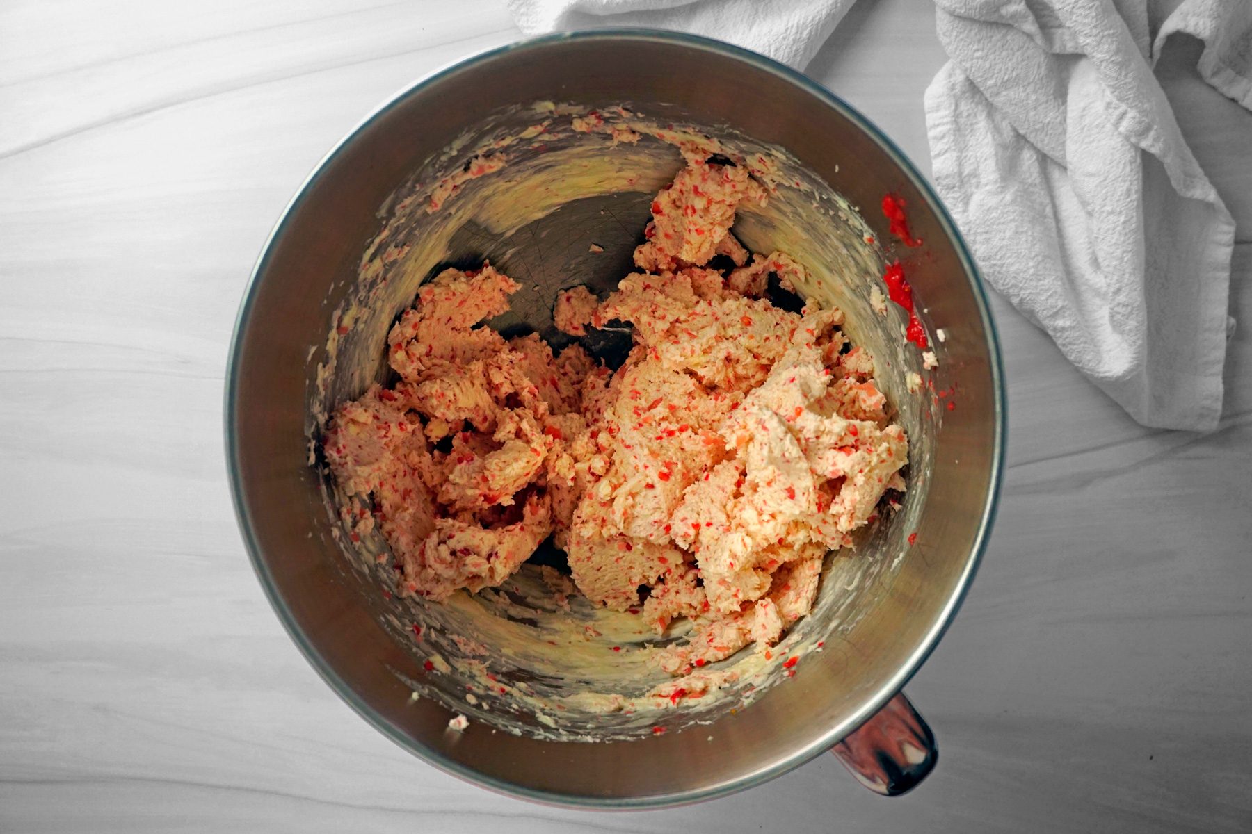 Adding blended stawberry into the butter mixture