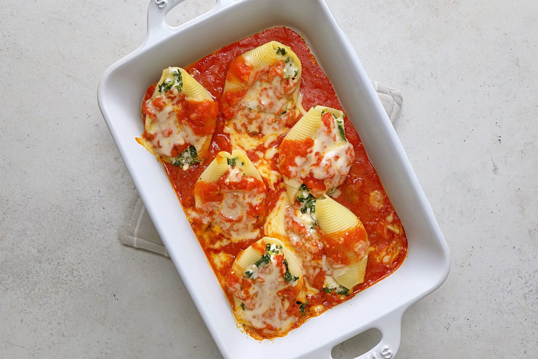 overhead shot of stuffed shells in a baking dish