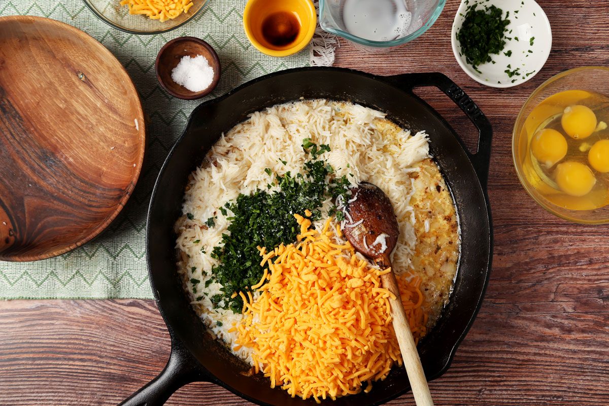 Process of making Taste of Home's Cheesy Rice Casserole in a green baking dish on a wooden surface.