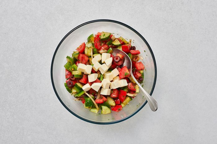 Cheese tossed into the salad before serving