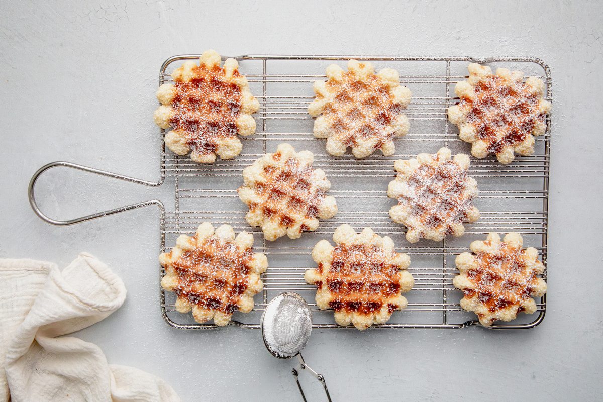 Waffle cookies on a wire rack for Taste of Home Waffle Cookies on a marble surface.