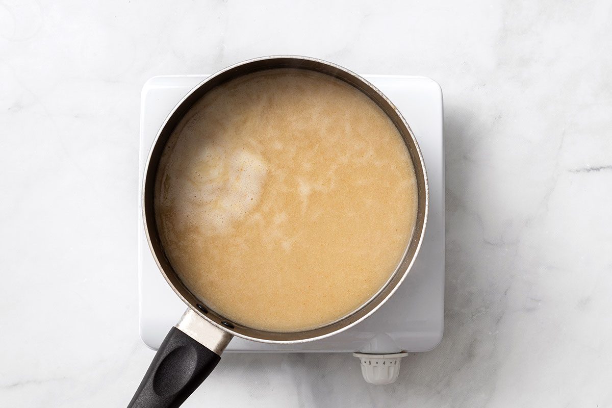 Chicken broth, cumin, garlic powder, salt and pepper in a saucepan
