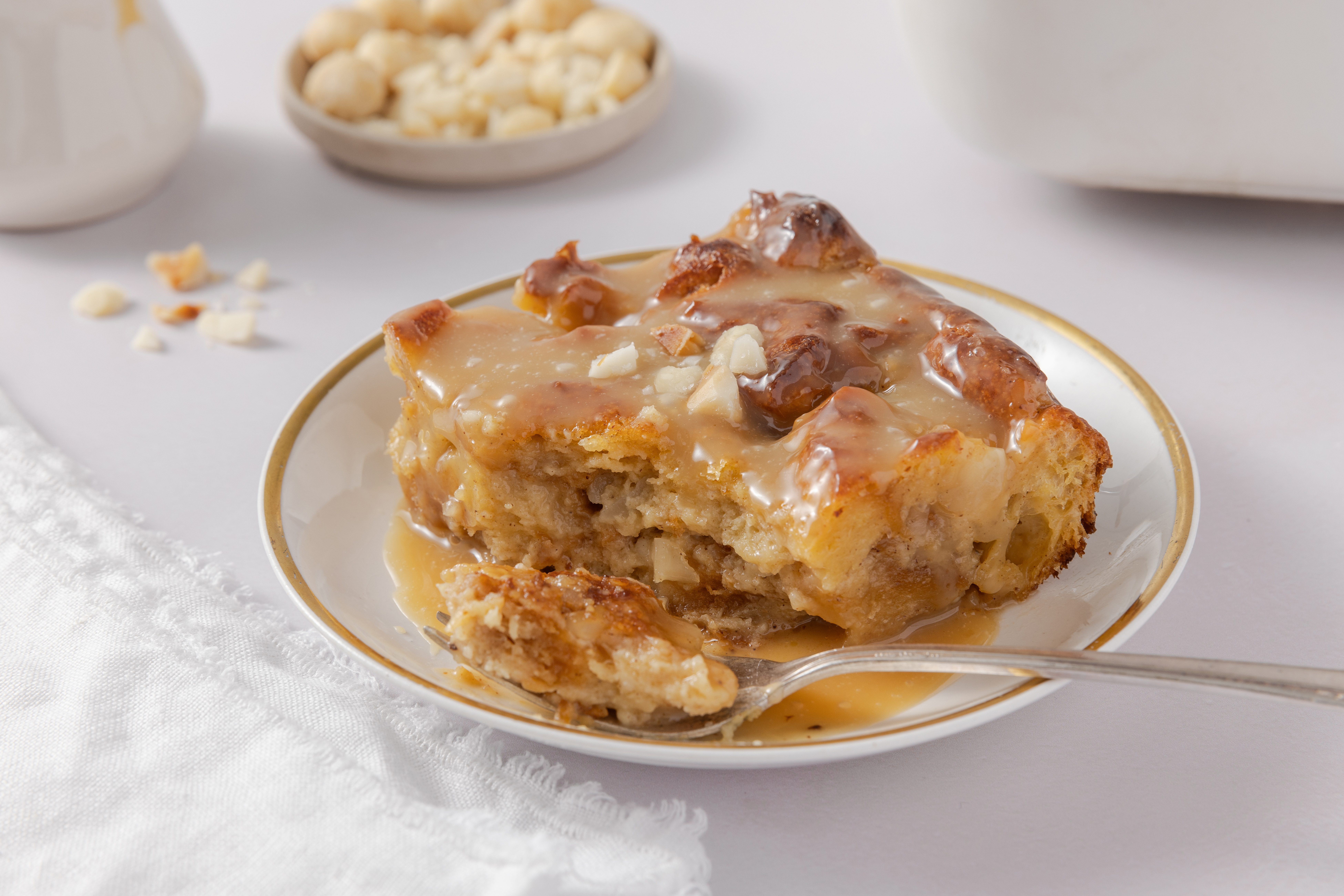 Close up of white chocolate bread pudding piece on a fork.