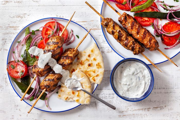 Adana Kabobs Served With Breads And Cacik