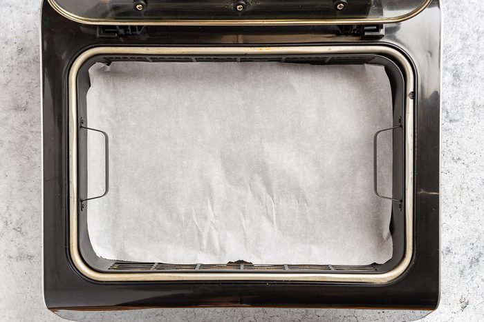 Taste of Home Air Fryer Apple Fritters photo of preparing the air fryer basket.