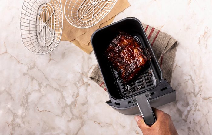 Air Fryer Pork Ribs cooking in air fryer